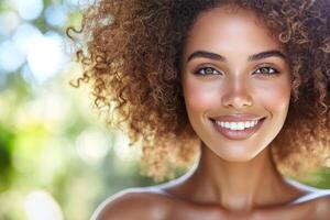 Smiling woman with curly hair poses against a wooden backdrop in natural light photo