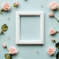 Floral decoration with white frame and pastel roses on soft blue background photo