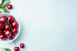 Fresh cherries glistening with water droplets in a silver bowl during a summer afternoon photo