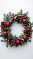 Festive red and green wreath with pinecones and ornaments for holiday decor photo