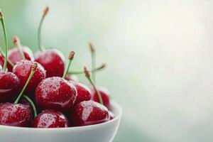 Fresh cherries glistening with water droplets in a silver bowl during a summer afternoon photo