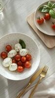 Fresh tomatoes and mozzarella served on a rustic table with basil garnish photo