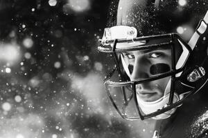 Intense football player wearing helmet and eye black during snowstorm at night photo