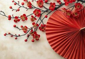 Colorful cherry blossom branch and decorative fan on a soft beige background for festive decor photo