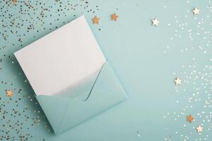 Blank card and envelope with golden stars on light blue background photo