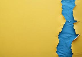Colorful torn paper revealing a vibrant blue section against a bright yellow background photo
