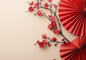 Colorful cherry blossom branch and decorative fan on a soft beige background for festive decor photo