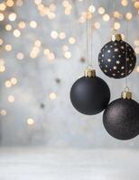 Decorative black and gold Christmas ornaments on a white background with glitter photo