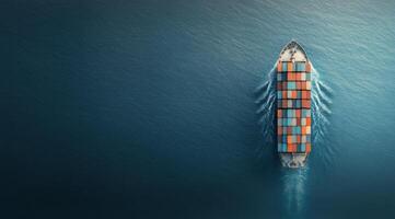 Cargo ship sails on calm waters while airplane flies above during sunset hour photo
