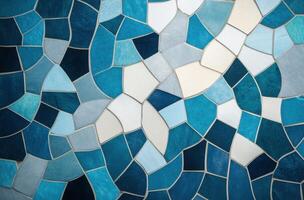 Abstract mosaic design featuring blue and white patterns resembling waves and water photo