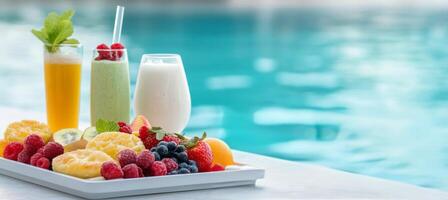 Refreshing poolside breakfast featuring smoothies, drinks, and fresh fruit photo
