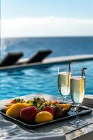Luxurious brunch by the pool featuring fresh fruits and sparkling beverages photo