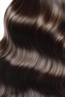Elegant wavy brunette hair displayed in soft curls and shine under natural light photo