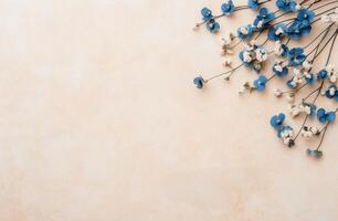 Blue flowers and white blossoms arranged on a beige background for a simple decor photo