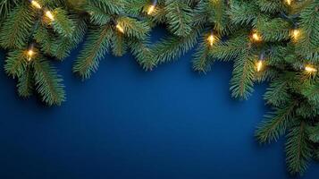 Fresh green pine branches adorned with warm, glowing lights during the holiday season photo