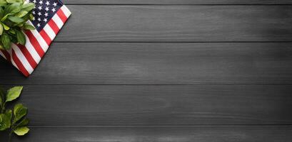 American flag resting on dark wooden surface with greenery photo
