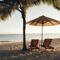 Relaxing beach chairs under a straw umbrella by the calm sea at sunset photo