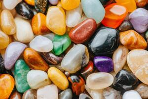 Colorful collection of smooth stones arranged on a flat surface for decoration and crafting photo