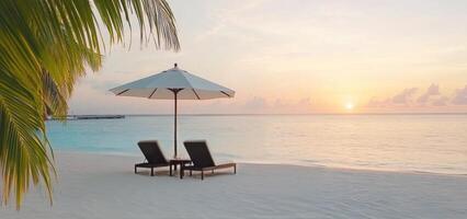 Relaxing evening at a serene beach with lounge chairs and an umbrella near the ocean photo