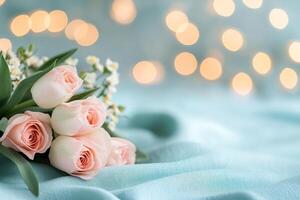 Beautiful bouquet of pink tulips on soft textured fabric with gentle bokeh lights photo