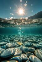 Sunlight dances on pebbles beneath clear water in a tranquil coastal environment photo