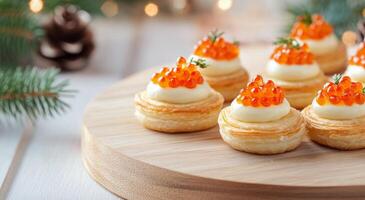 Delicate pastry cups filled with cream and topped with fish roe and herbs for a festive occasion photo