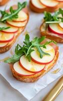 Delicious apple and arugula toast with ham on crisp bread for a healthy snack option photo