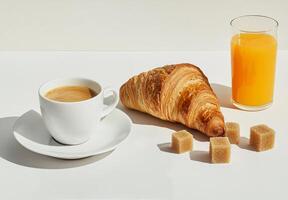 Enjoying a morning coffee with a croissant and fresh orange juice on a bright table photo