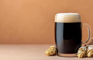 Dark beer served in a frosty mug with hops on a rustic surface photo