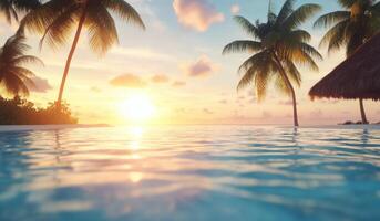 Serene sunset view over a tranquil pool with palm trees by the beach photo