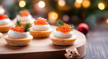 Delicate pastry cups filled with cream and topped with fish roe and herbs for a festive occasion photo