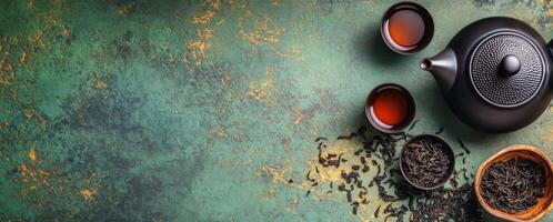 Delicious black tea preparation with a teapot and dried tea leaves on a rustic table photo