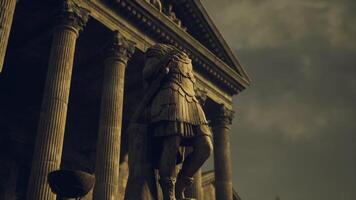Majestic ancient statue stands before grand classical architecture in twilight video