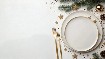 Elegant holiday table setting with white plate and golden utensils on a festive background photo