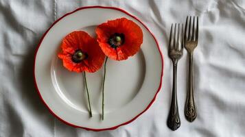 Elegant dining table setting with red poppy flowers on a decorative plate during a special occasion photo