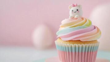 Colorful cupcake with pink frosting and decorative figure on a pastel background photo