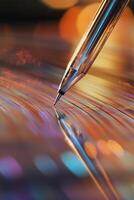Close up of a record player needle on a spinning vinyl disc illuminated by red light photo