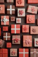 Colorful collection of wrapped gifts arranged on a wall in various shades of red and pink photo