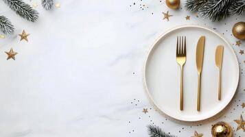 Elegant holiday table setting with white plate and golden utensils on a festive background photo
