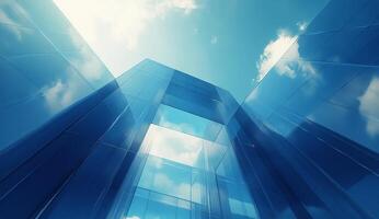 Reflective glass architecture reaching toward the blue sky with scattered clouds during daytime photo