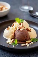 Delicious dessert with chocolate and vanilla ice cream topped with nuts on a plate photo