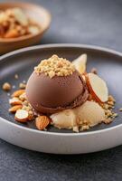 Delicious dessert with chocolate and vanilla ice cream topped with nuts on a plate photo