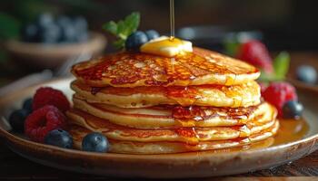 Stack of Golden Pancakes Drizzled with Syrup and Topped with Berries photo