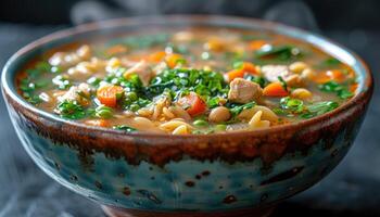 Steaming Bowl of Chicken Noodle Soup with Vegetables photo