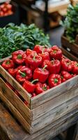 Fresh red bell peppers stacked in wooden crates at a vibrant market during daylight hours photo