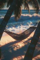 Relaxing hammock on the beach at sunset with beautiful clouds and ocean waves in the background photo