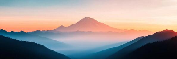 Serene sunrise over mountains with a distant peak and misty valleys at dawn photo