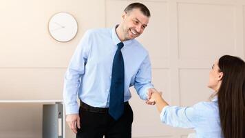 Career And Employment. Mature Man Shaking Hands With HR-Manager Lady On Job Interview In Modern Office. Selective Focus photo