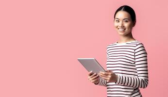Modern Technologies For Leisure. Portrait Of Young Asian Female Using Digital Tablet And Smiling At Camera, Happy Korean Woman With Modern Device In Hands Posing Over Pink Background, Copy Space photo