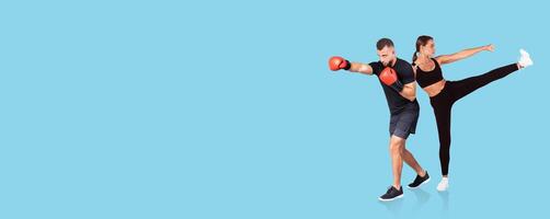 Two individuals are exercising together, with one throwing a punch and the other performing a high kick. photo